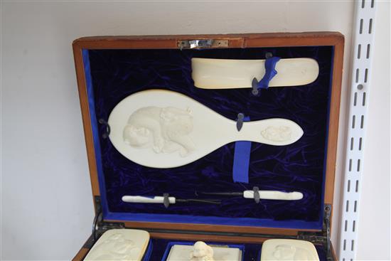 A Japanese Meiji period eight piece ivory dressing table set, 14in.